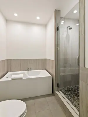 a bathroom with a tub and a toilet and a shower at Oceanview Townhome Just Steps from Iconic Windansea Beach in San Diego