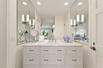 a white bathroom with two sinks and mirrors at Oceanview Townhome Just Steps from Iconic Windansea Beach in San Diego