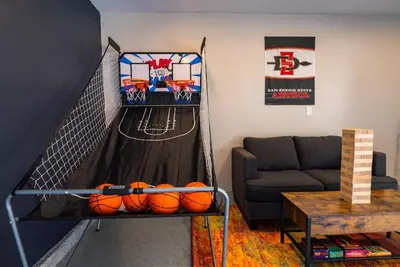 a living room with a basketball net with balls on it at SDSU and Downtown Less Than 10 Min, Game Room, and Fire Pit in La Mesa