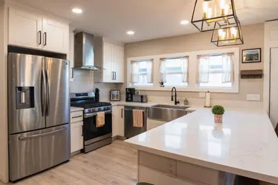 a kitchen with stainless steel appliances and white cabinets at SDSU and Downtown Less Than 10 Min, Game Room, and Fire Pit in La Mesa