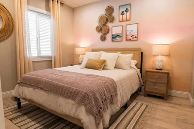 a bedroom with a large bed and a window at SDSU and Downtown Less Than 10 Min, Game Room, and Fire Pit in La Mesa