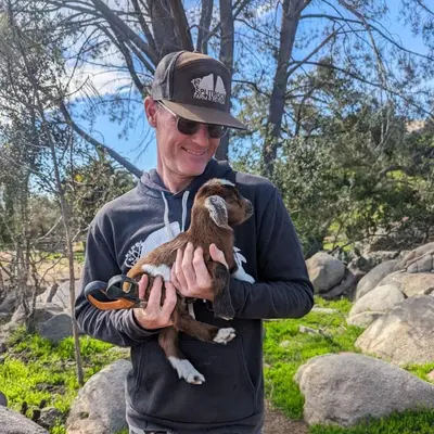 a man holding a baby duck in his hands at Gentle and Cozy Comfort in an Off-Grid Retreat in Fallbrook