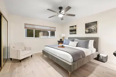 a bedroom with a bed and a ceiling fan at Hills Hideaway by CoastVH - Luxury Midtown 3br in San Diego