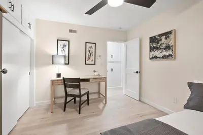 a bedroom with a desk with a chair and a bed at Hills Hideaway by CoastVH - Luxury Midtown 3br in San Diego