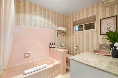 a pink bathroom with a tub and a sink at Hills Hideaway by CoastVH - Luxury Midtown 3br in San Diego