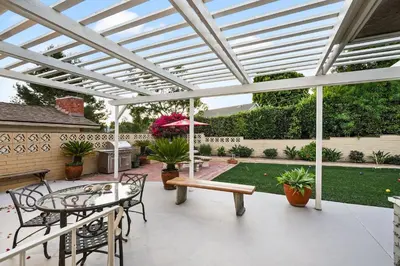 a patio with a pergola and a table and chairs at Hills Hideaway by CoastVH - Luxury Midtown 3br in San Diego