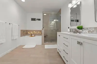 a white bathroom with a shower and a sink at Immaculate 5BR Micro Resort with Heated Pool & Spa in San Diego