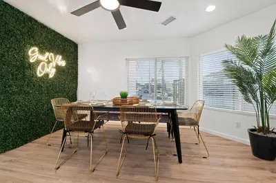 a dining room with a black table and chairs at Immaculate 5BR Micro Resort with Heated Pool & Spa in San Diego