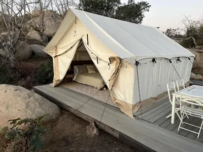 a canvas tent sitting on a wooden deck at A Cozy Sunrise Glamping Escape with Panoramic View in Fallbrook