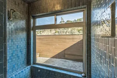 a bathroom with a window and a shower with blue tiles at Ocean View beach house Ocean View beach house-STR14-0105 & STR14-0133 in Dana Point