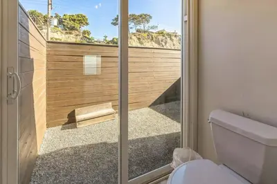 a bathroom with a toilet and a glass shower door at Ocean View beach house Ocean View beach house-STR14-0105 & STR14-0133 in Dana Point