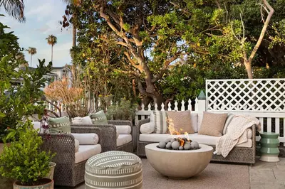 a patio with wicker furniture and a fire pit at Nantucket-Style - Steps to Beach Rooftop Deck Ocean Views in San Diego