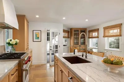 a kitchen with a sink and a counter top at Nantucket-Style - Steps to Beach Rooftop Deck Ocean Views in San Diego