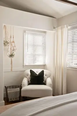 a white bedroom with a chair with a black pillow at Nantucket-Style - Steps to Beach Rooftop Deck Ocean Views in San Diego