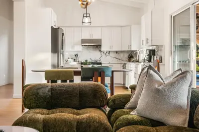 a living room with a couch and a kitchen at # Marbella Lane - Home with Ocean & Golf Course Views in San Clemente