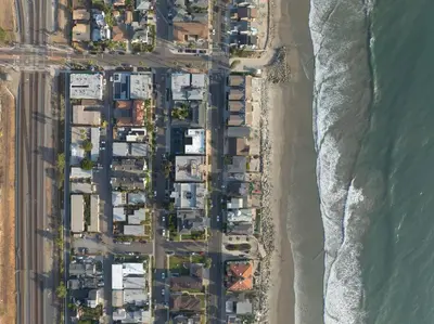 an aerial view of a beach with houses at King Suite - Steps to Beach & Close to Pier in Oceanside