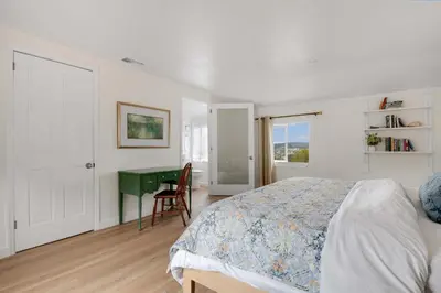 a bedroom with a bed and a green desk at The Porter House - Sweeping Ocean Views - La Jolla in San Diego
