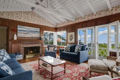 a living room with blue furniture and a fireplace at The Porter House - Sweeping Ocean Views - La Jolla in San Diego