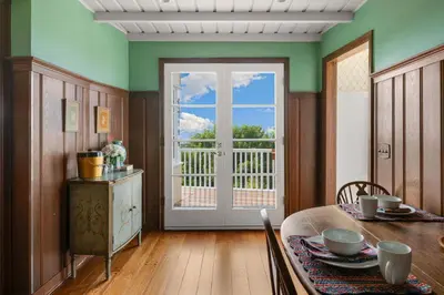 a dining room with a table and a sliding glass door at The Porter House - Sweeping Ocean Views - La Jolla in San Diego