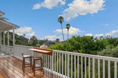 a porch with a table and two chairs on a deck at The Porter House - Sweeping Ocean Views - La Jolla in San Diego
