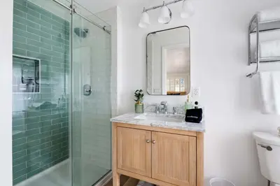 a bathroom with a shower and a sink and a mirror at The Porter House - Sweeping Ocean Views - La Jolla in San Diego