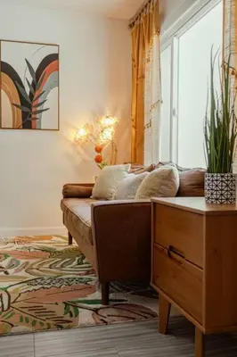 a living room with a couch and a table at Steps to Beach & Close to Restaurants and Shops in Oceanside