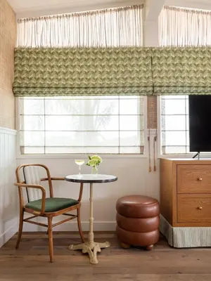 a table and a chair in a room with a window at Le Petit Pali Laguna Beach in Laguna Beach