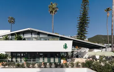 a building with the letter b on it in front of palm trees at Le Petit Pali Laguna Beach in Laguna Beach