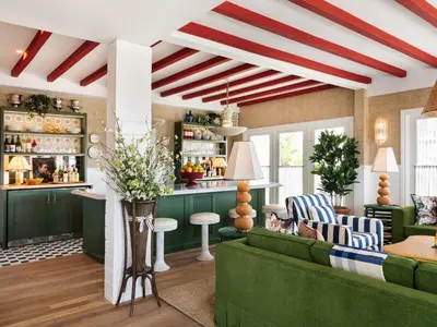 a living room with a green couch and a bar at Le Petit Pali Laguna Beach in Laguna Beach