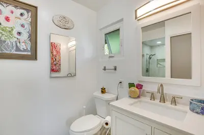 a white bathroom with a toilet and a sink at Mt Nebo Oasis in La Mesa with Wraparound Deck in La Mesa