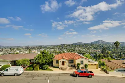 a house with two cars parked in a parking lot at Mt Nebo Oasis in La Mesa with Wraparound Deck in La Mesa