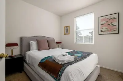 a bedroom with a bed and a window at Redecorated - Serene- Legoland- Family-Friendly in Carlsbad