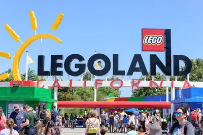 a crowd of people walking in front of a sign at a fair at Redecorated - Serene- Legoland- Family-Friendly in Carlsbad