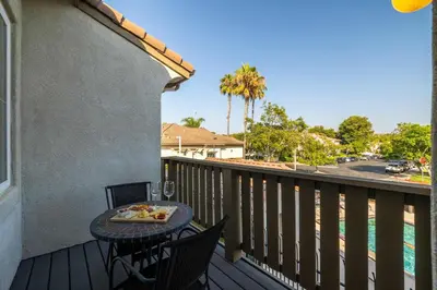 a balcony with a table with a tray of food on it at Redecorated - Serene- Legoland- Family-Friendly in Carlsbad
