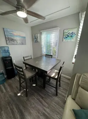 a dining room with a wooden table and chairs at Home away from Home in San Diego