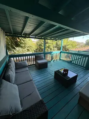 a porch with a couch and a table on a deck at Home away from Home in San Diego