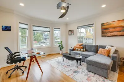 a living room with a couch and a table at Steps to Balboa Park Sunny Historic Apartment in San Diego