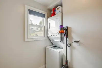 a washer and dryer in a kitchen with a window at Steps to Balboa Park Sunny Historic Apartment in San Diego
