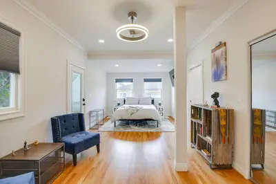 a bedroom with a bed and a couch and a chair at Steps to Balboa Park Sunny Historic Apartment in San Diego