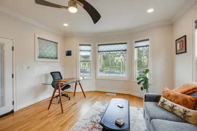 a living room with a couch and a table at Steps to Balboa Park Sunny Historic Apartment in San Diego