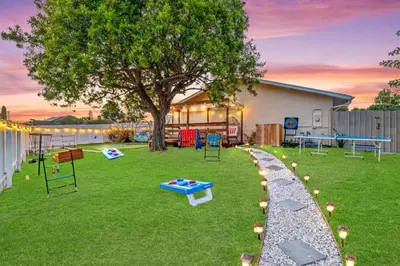 a yard with a tree and a table and chairs at Majestic Lux Home with Heated Pool and Spa! in San Diego
