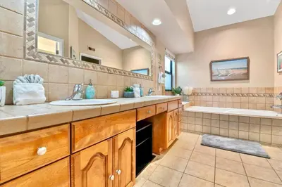 a bathroom with two sinks and a large mirror at Majestic Views Pool&Jacuzzi, Mini Golf, Playground in Spring Valley