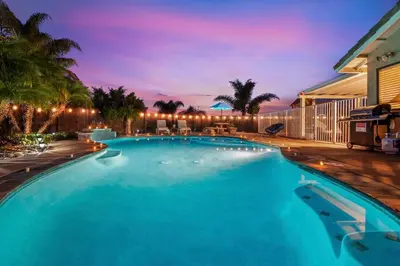 a large blue swimming pool with palm trees at Majestic Views Pool&Jacuzzi, Mini Golf, Playground in Spring Valley