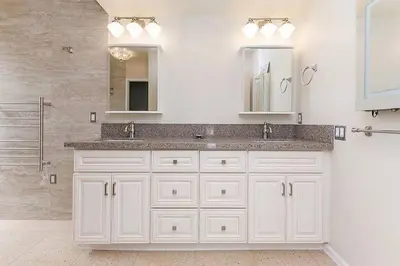 a white bathroom with a sink and mirrors at Majestic 5BR Villa with Guesthouse, Pool & Spa in Poway