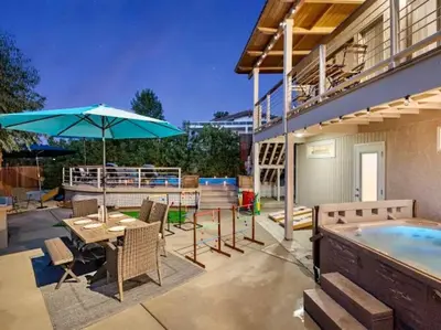 a patio with a pool and a table and an umbrella at Majestic 5BR Villa with Guesthouse, Pool & Spa in Poway