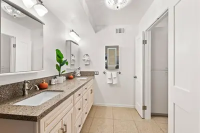 a bathroom with a sink and a large mirror at Majestic 5BR Villa with Guesthouse, Pool & Spa in Poway