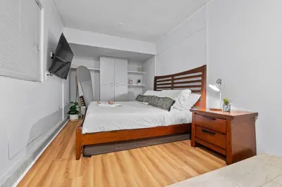 a bedroom with a bed and a desk and a tv at Majestic 5BR Villa with Guesthouse, Pool & Spa in Poway