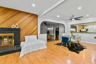 a living room with a fireplace and a table and chairs at Massive 5BR Resort Style Retreat with Heated Pool in San Diego