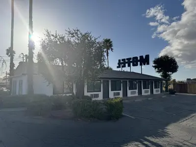 a building with a sign on top of it at Sun Leisure Motel in Menifee