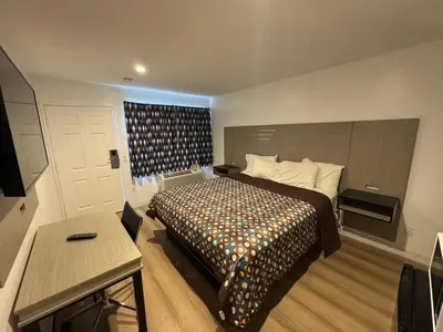 a hotel room with a bed and a table at Sun Leisure Motel in Menifee